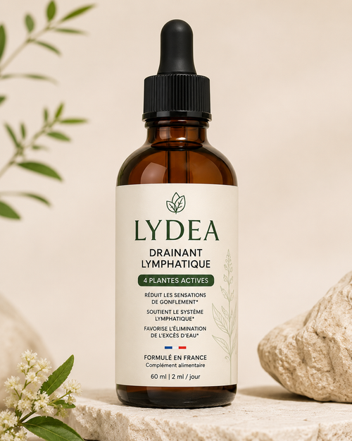 Flacon ambré LYDEA Drainant Lymphatique, 60 ml, pipette noire, posé sur une pierre claire